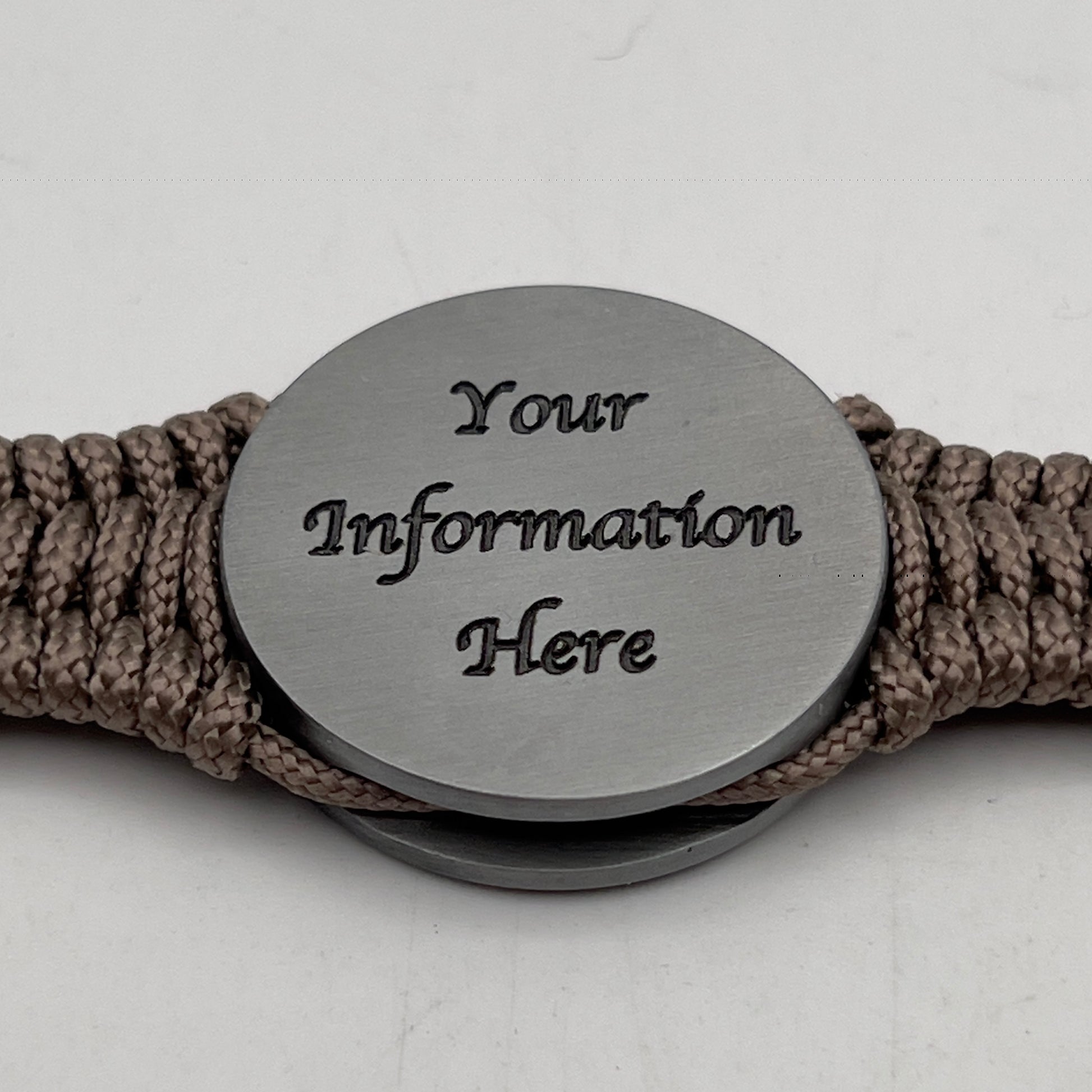 Thin, narrow, flexible and comfortable braided United States Marine Corps Iwo Jima bracelet featuring an antique silver plated UV painted Iwo Jima flag raising medallion, a silver Cobra style tactical buckle and woven with tan type-1 paracord.