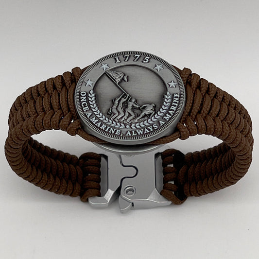 Thin, narrow, flexible and comfortable braided United States Marine Corps Iwo Jima bracelet featuring an antique silver plated Iwo Jima flag raising medallion, a silver Cobra style tactical buckle and woven with Coyote Brown type-1 paracord.
