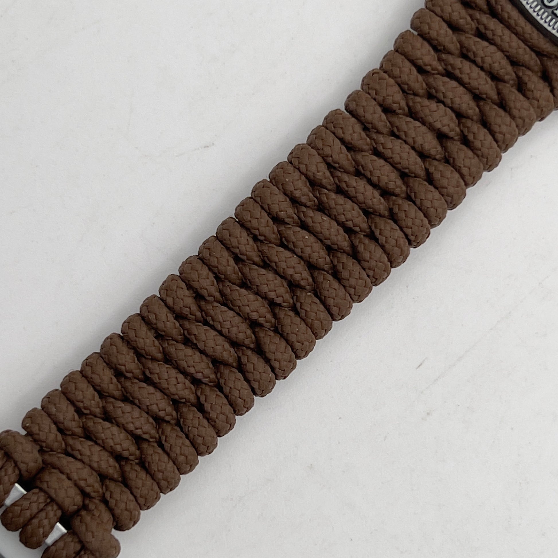 Thin, narrow, flexible and comfortable braided United States Marine Corps Iwo Jima bracelet featuring an antique silver plated Iwo Jima flag raising medallion, a silver Cobra style tactical buckle and woven with Coyote Brown type-1 paracord.