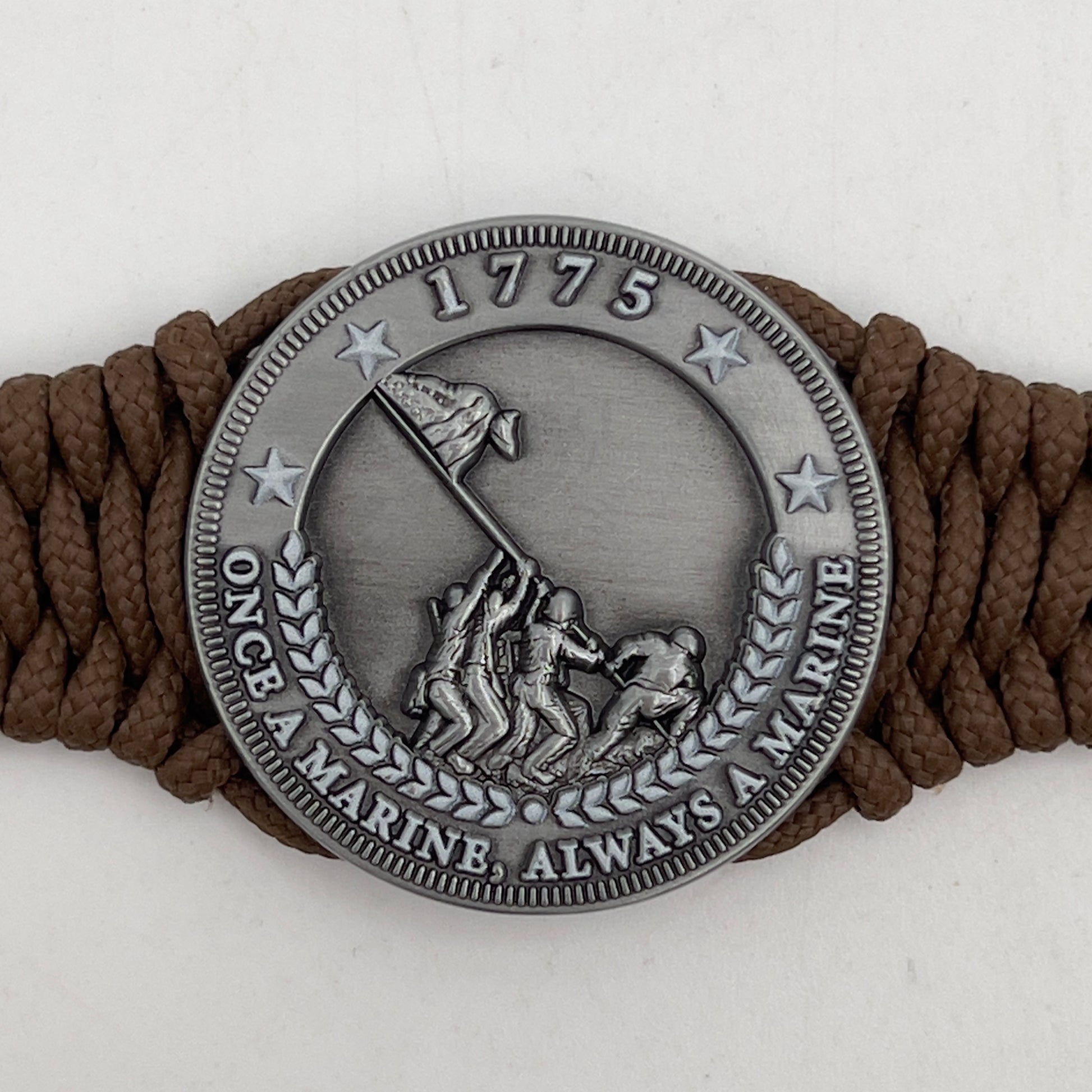 Thin, narrow, flexible and comfortable braided United States Marine Corps Iwo Jima bracelet featuring an antique silver plated Iwo Jima flag raising medallion, a silver Cobra style tactical buckle and woven with Coyote Brown type-1 paracord.