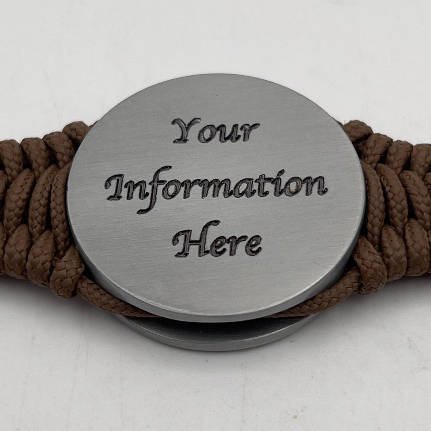Thin, narrow, flexible and comfortable braided United States Marine Corps Iwo Jima bracelet featuring an antique silver plated Iwo Jima flag raising medallion, a silver Cobra style tactical buckle and woven with Coyote Brown type-1 paracord.