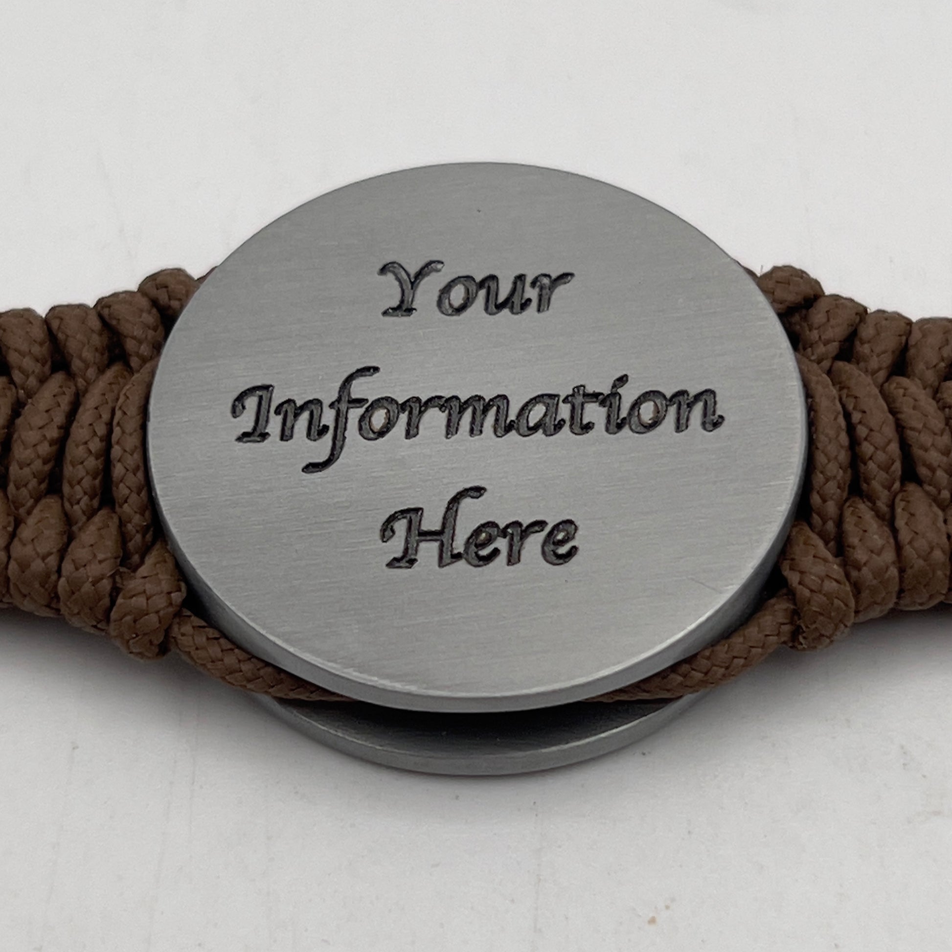 Thin, narrow, flexible and comfortable braided United States Marine Corps Iwo Jima bracelet featuring an antique silver plated Iwo Jima flag raising medallion, a silver Cobra style tactical buckle and woven with Coyote Brown type-1 paracord.