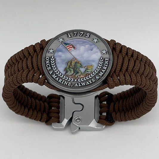 Thin, narrow, flexible and comfortable braided United States Marine Corps Iwo Jima bracelet featuring an antique silver plated UV painted Iwo Jima flag raising medallion, a silver Cobra style tactical buckle and woven with Coyote Brown type-1 paracord.