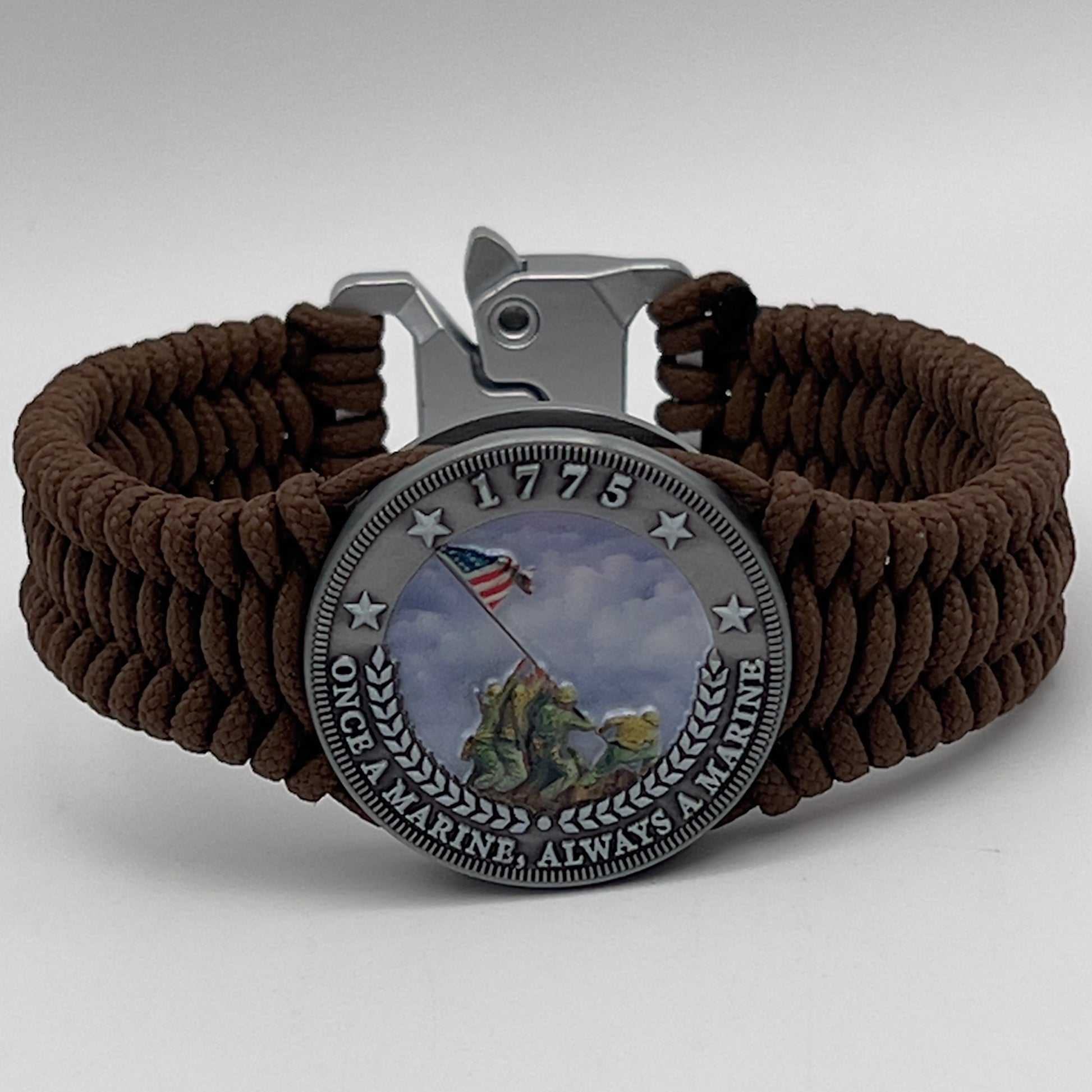 Thin, narrow, flexible and comfortable braided United States Marine Corps Iwo Jima bracelet featuring an antique silver plated UV painted Iwo Jima flag raising medallion, a silver Cobra style tactical buckle and woven with Coyote Brown type-1 paracord.