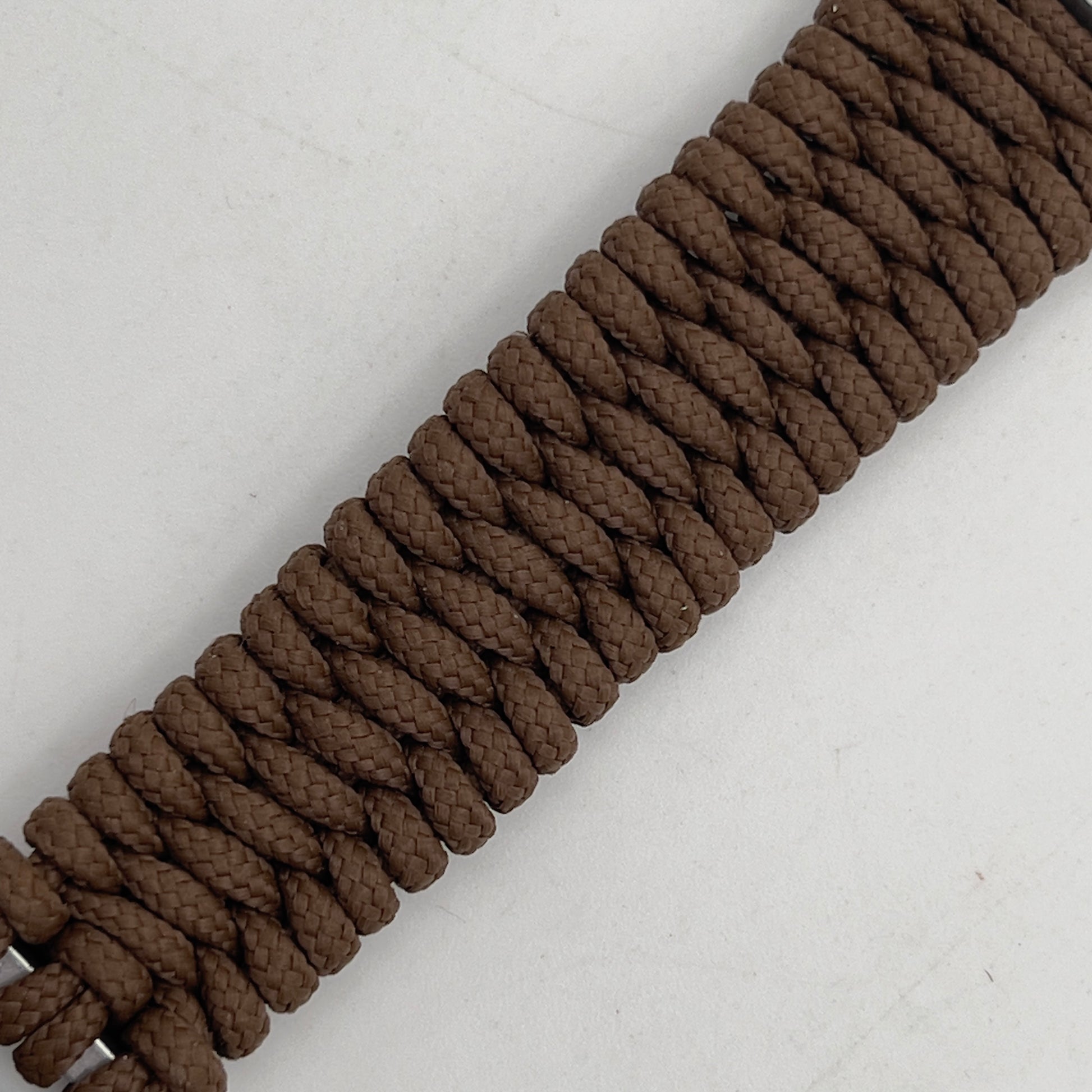 Thin, narrow, flexible and comfortable braided United States Marine Corps Iwo Jima bracelet featuring an antique silver plated UV painted Iwo Jima flag raising medallion, a silver Cobra style tactical buckle and woven with Coyote Brown type-1 paracord.