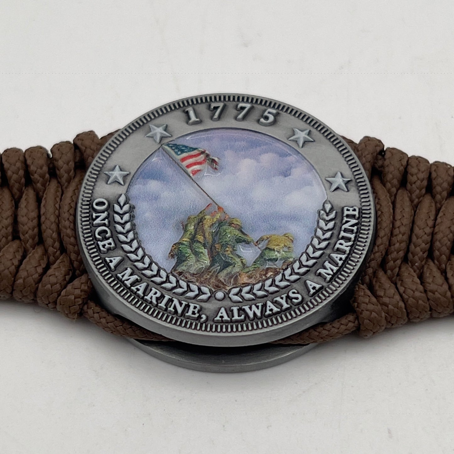 Thin, narrow, flexible and comfortable braided United States Marine Corps Iwo Jima bracelet featuring an antique silver plated UV painted Iwo Jima flag raising medallion, a silver Cobra style tactical buckle and woven with Coyote Brown type-1 paracord.