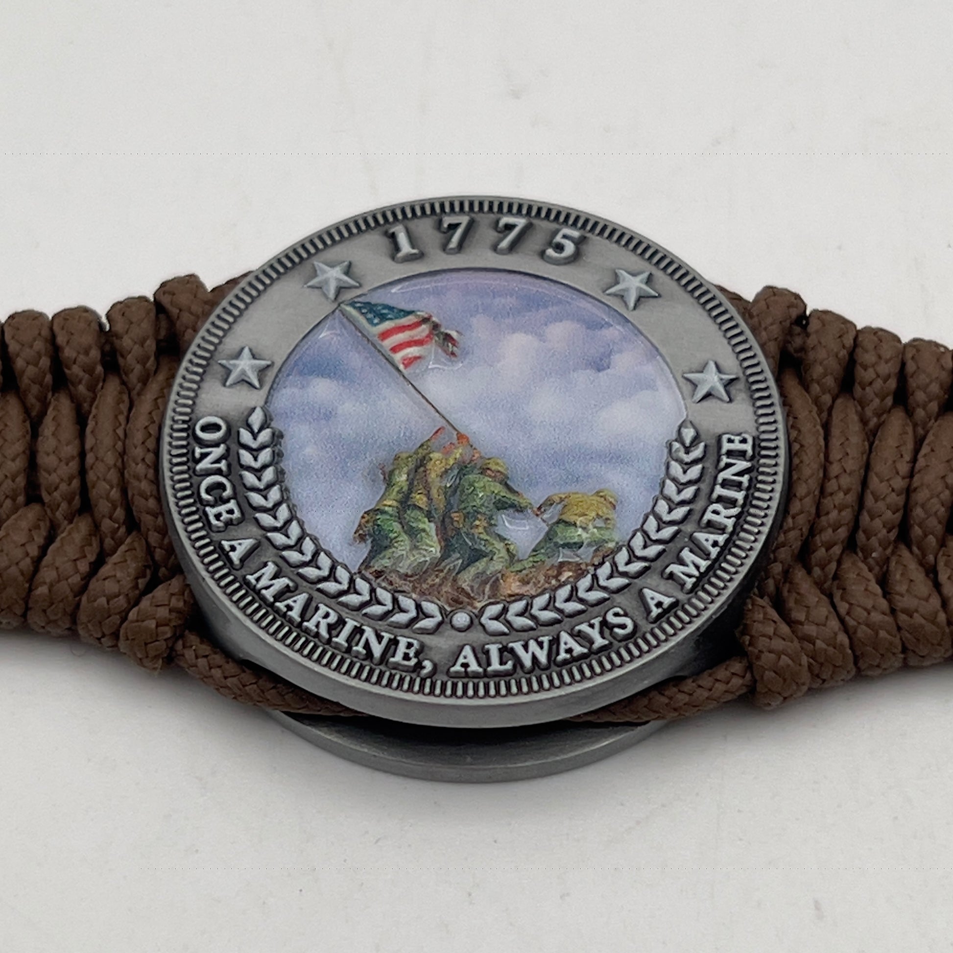Thin, narrow, flexible and comfortable braided United States Marine Corps Iwo Jima bracelet featuring an antique silver plated UV painted Iwo Jima flag raising medallion, a silver Cobra style tactical buckle and woven with Coyote Brown type-1 paracord.