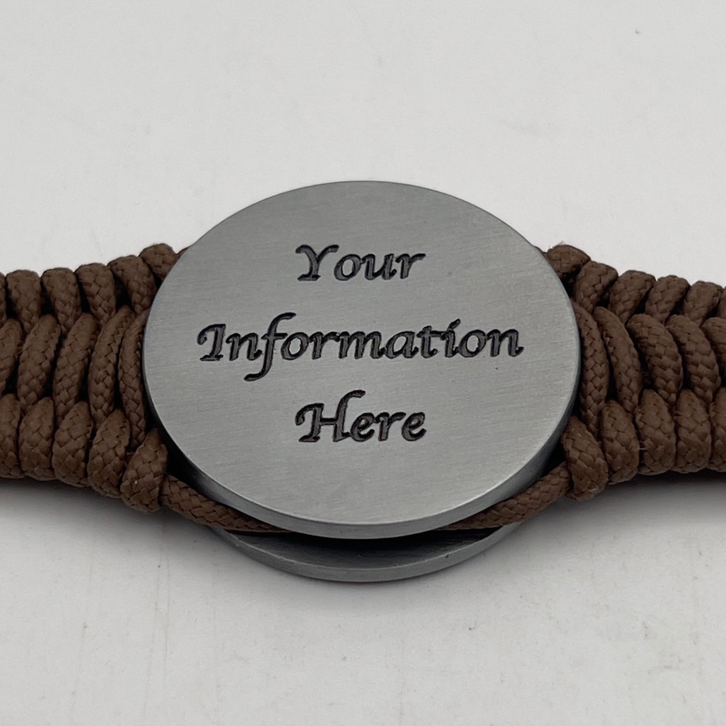 Thin, narrow, flexible and comfortable braided United States Marine Corps Iwo Jima bracelet featuring an antique silver plated UV painted Iwo Jima flag raising medallion, a silver Cobra style tactical buckle and woven with Coyote Brown type-1 paracord.