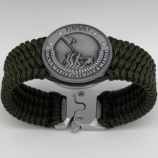 Thin, wide, flexible and comfortable braided United States Marine Corps Iwo Jima bracelet featuring an antique silver plated Iwo Jima flag raising medallion, a silver Cobra style tactical buckle and woven with olive drab type-1 paracord.