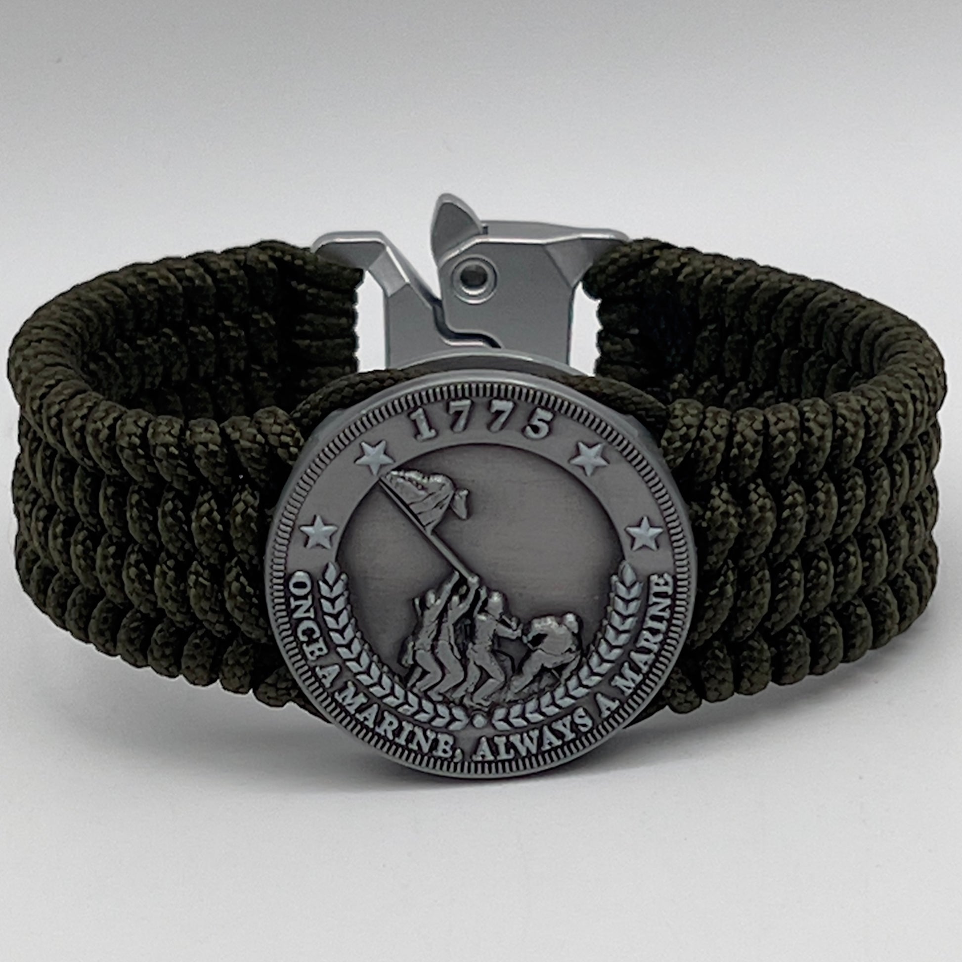 Thin, wide, flexible and comfortable braided United States Marine Corps Iwo Jima bracelet featuring an antique silver plated Iwo Jima flag raising medallion, a silver Cobra style tactical buckle and woven with olive drab type-1 paracord.