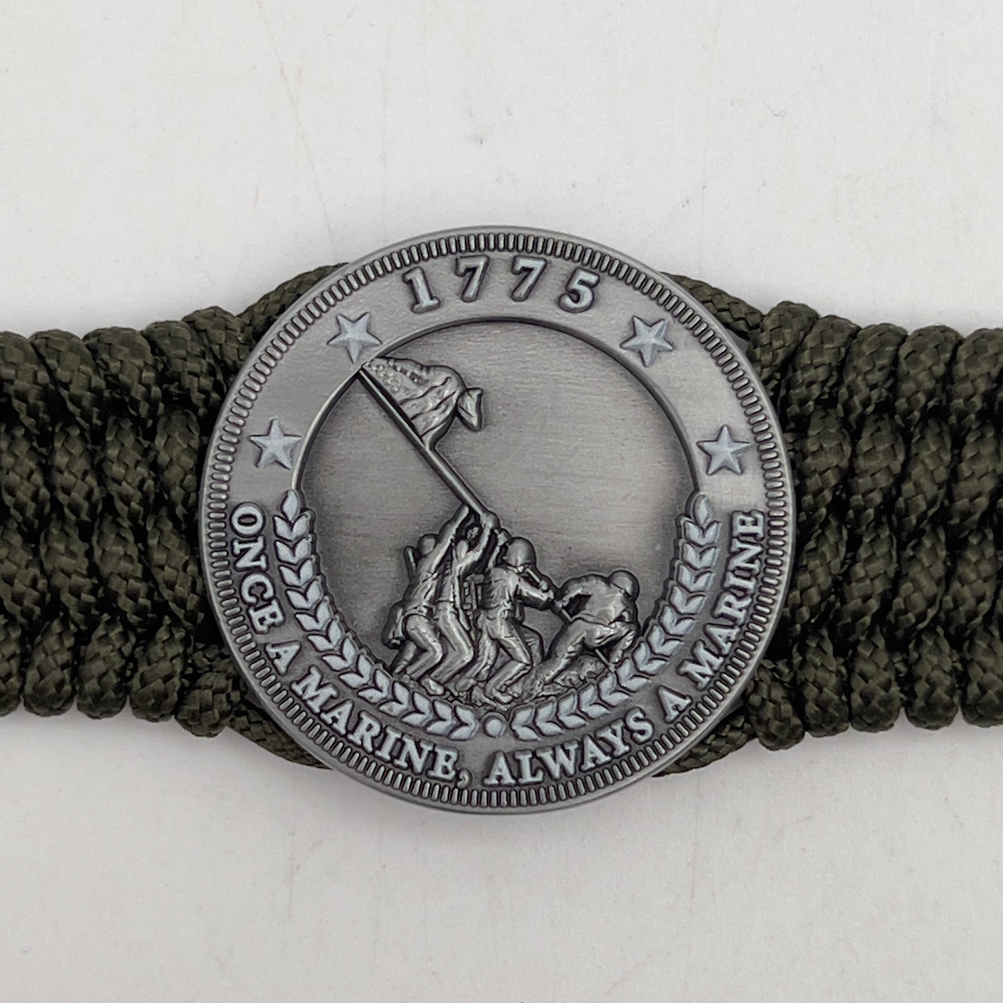 Thin, wide, flexible and comfortable braided United States Marine Corps Iwo Jima bracelet featuring an antique silver plated Iwo Jima flag raising medallion, a silver Cobra style tactical buckle and woven with olive drab type-1 paracord.