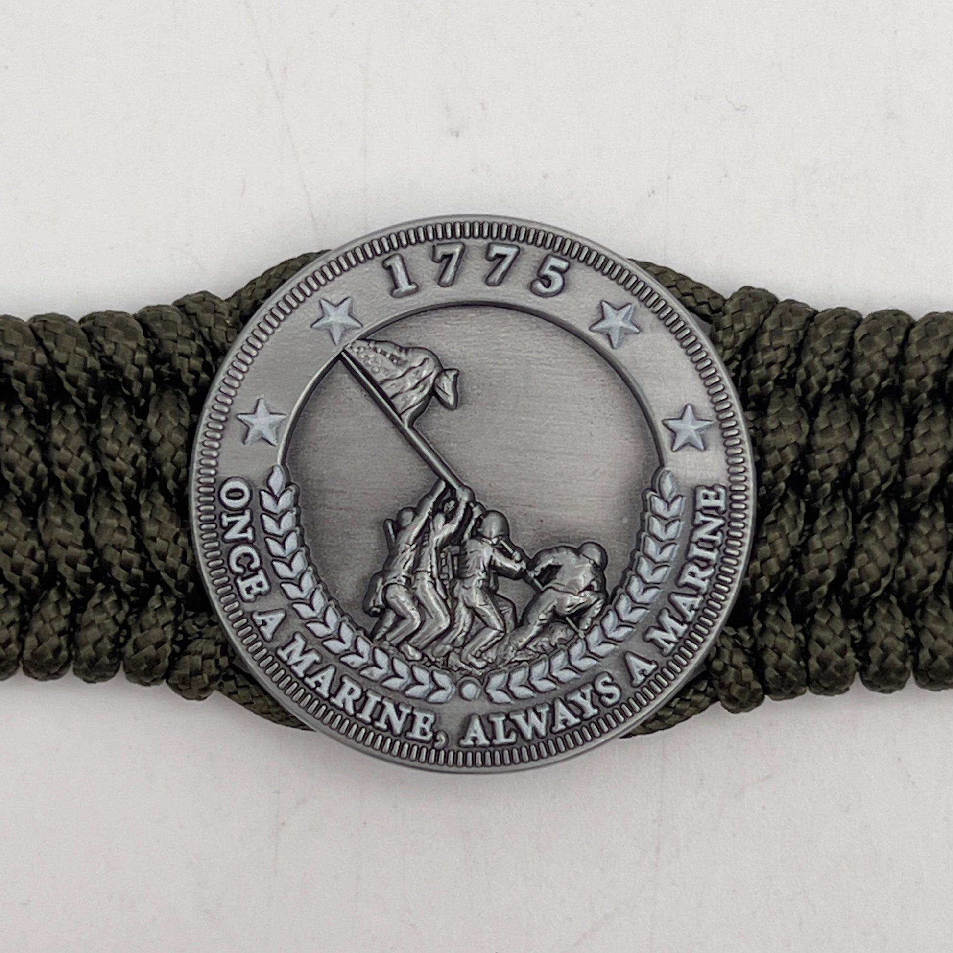 Thin, wide, flexible and comfortable braided United States Marine Corps Iwo Jima bracelet featuring an antique silver plated Iwo Jima flag raising medallion, a silver Cobra style tactical buckle and woven with olive drab type-1 paracord.