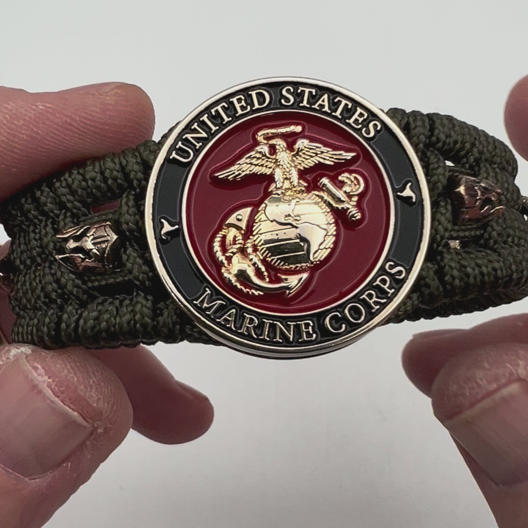 Thin, medium width, flexible and comfortable braided United States Marine Corps bracelet featuring a 24K gold plated USMC officer Eagle Globe and Anchor medallion, six Spartan micro beads, a gold Cobra style tactical buckle and woven with Olive Drab Type-1 paracord.