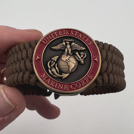 Thin, medium wide, flexible and comfortable braided United States Marine Corps bracelet featuring a 24K antique gold plated USMC Eagle Globe and Anchor medallion, a gold Cobra style tactical buckle and woven with Coyote Brown Type-1 paracord.