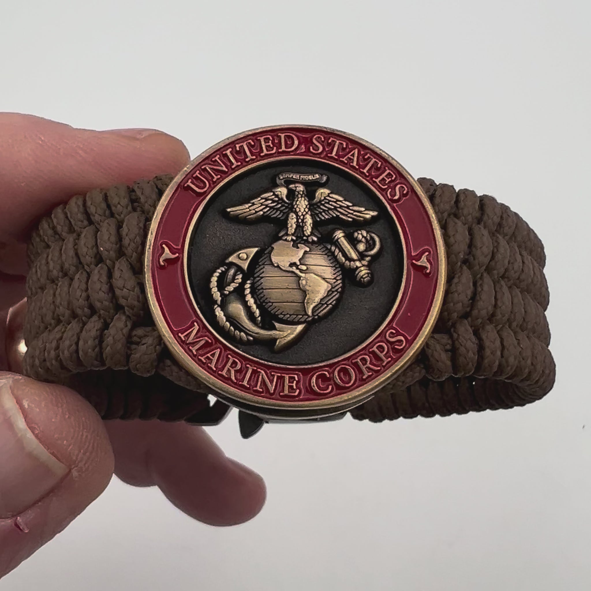 Thin, medium wide, flexible and comfortable braided United States Marine Corps bracelet featuring a 24K antique gold plated USMC Eagle Globe and Anchor medallion, a gold Cobra style tactical buckle and woven with Coyote Brown Type-1 paracord.
