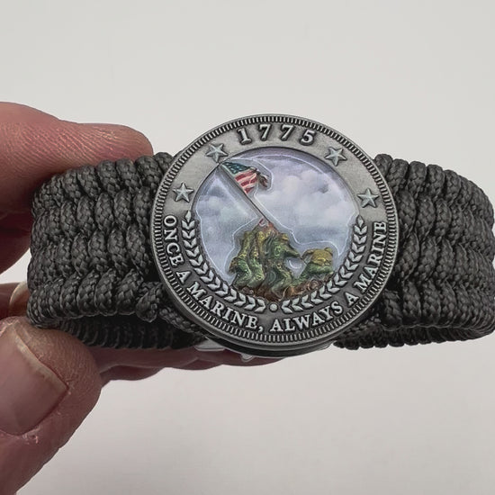 Thin, wide, flexible and comfortable braided United States Marine Corps Iwo Jima bracelet featuring an antique silver plated Iwo Jima flag raising medallion, a silver Cobra style tactical buckle and woven with gray Type-1 paracord.