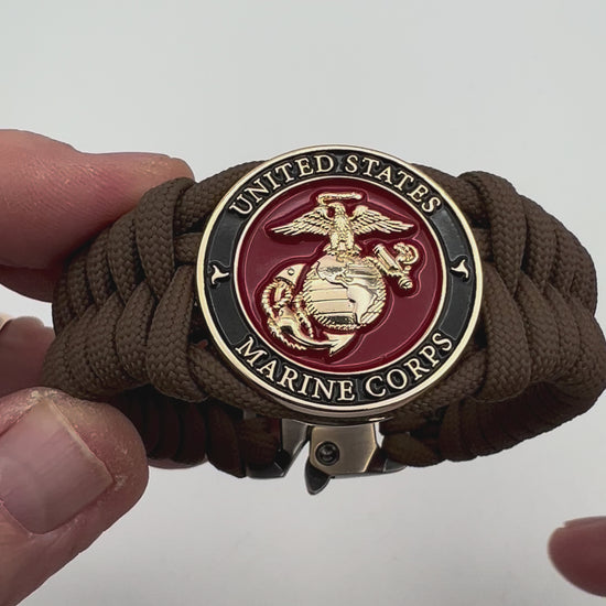 Thick, semi-rigid and comfortable braided United States Marine Corps bracelet featuring a 24K gold plated USMC Eagle Globe and Anchor medallion, a gold Cobra style tactical buckle and woven with Coyote Brown 550 paracord.