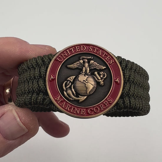 Thin, medium wide, flexible and comfortable braided United States Marine Corps bracelet featuring a 24K antique gold plated USMC Eagle Globe and Anchor medallion, a gold Cobra style tactical buckle and woven with Olive Drab Type-1 paracord.