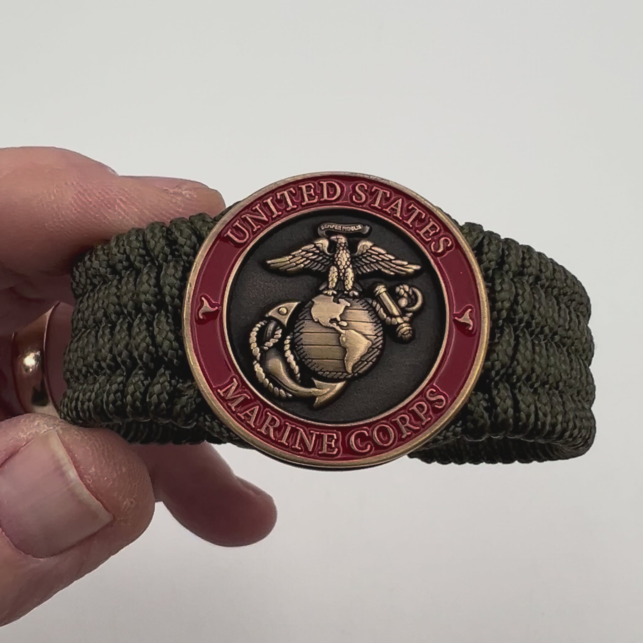 Thin, medium wide, flexible and comfortable braided United States Marine Corps bracelet featuring a 24K antique gold plated USMC Eagle Globe and Anchor medallion, a gold Cobra style tactical buckle and woven with Olive Drab Type-1 paracord.