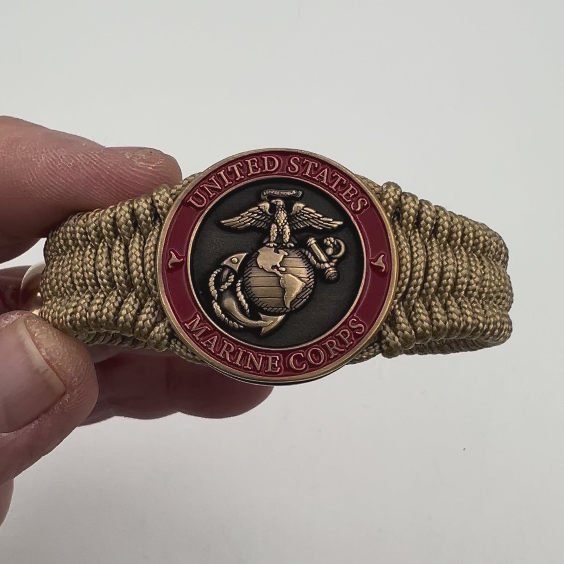 Thin, narrow, very thin and flexible and comfortable braided United States Marine Corps bracelet featuring a 24K antique gold plated USMC Eagle Globe and Anchor medallion, a gold Cobra style tactical buckle and woven with gold Type-1 paracord.