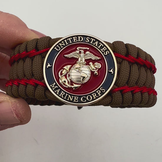 Thick and comfortable braided United States Marine Corps bracelet featuring a 24K gold and silver plated USMC officer Eagle Globe and Anchor medallion, a Cobra style tactical buckle and woven with Coyote Brown 550 paracord and Imperial Red micro cord.