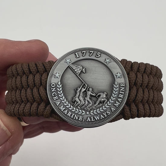 Thin, wide, flexible and comfortable braided United States Marine Corps Iwo Jima bracelet featuring an antique silver plated Iwo Jima flag raising medallion, a silver Cobra style tactical buckle and woven with Coyote Brown Type-1 paracord.