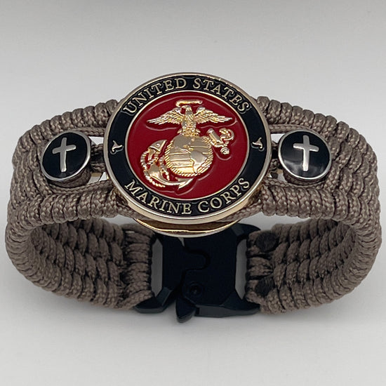 Thin, medium width, flexible and comfortable braided United States Marine Corps bracelet featuring a 24K gold plated USMC officer Eagle Globe and Anchor medallion, two Christian crosses, a black Cobra style tactical buckle and woven with Tan Type-1 paracord.