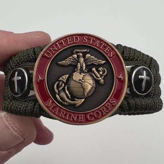 Thin, medium width, flexible and comfortable braided United States Marine Corps bracelet featuring a 24K antique gold plated USMC officer Eagle Globe and Anchor medallion, two Christian crosses, a black Cobra style tactical buckle and woven with Olive Drab Type-1 paracord.
