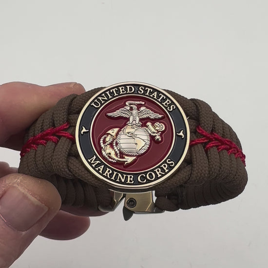 Thick, semi-rigid and comfortable braided United States Marine Corps bracelet featuring a 24K gold and silver plated USMC officer Eagle Globe and Anchor medallion, a Cobra style tactical buckle and woven with Coyote brown 550 and Imperial red micro paracord.