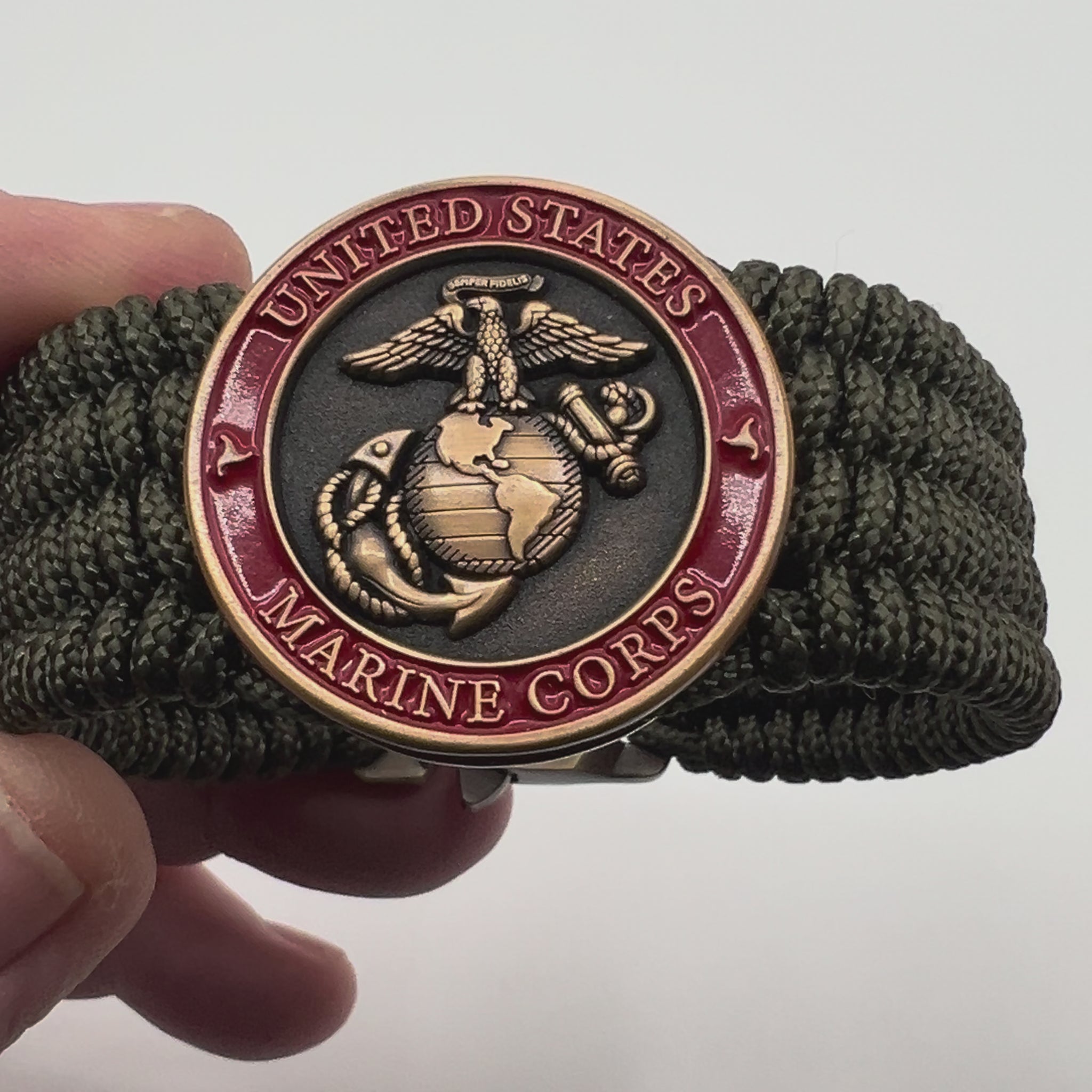 Thin, wide, very flexible and comfortable braided United States Marine Corps bracelet featuring a 24K antique gold plated USMC Eagle Globe and Anchor medallion, a gold Cobra style tactical buckle and woven with OIive Drab Type-1 paracord.